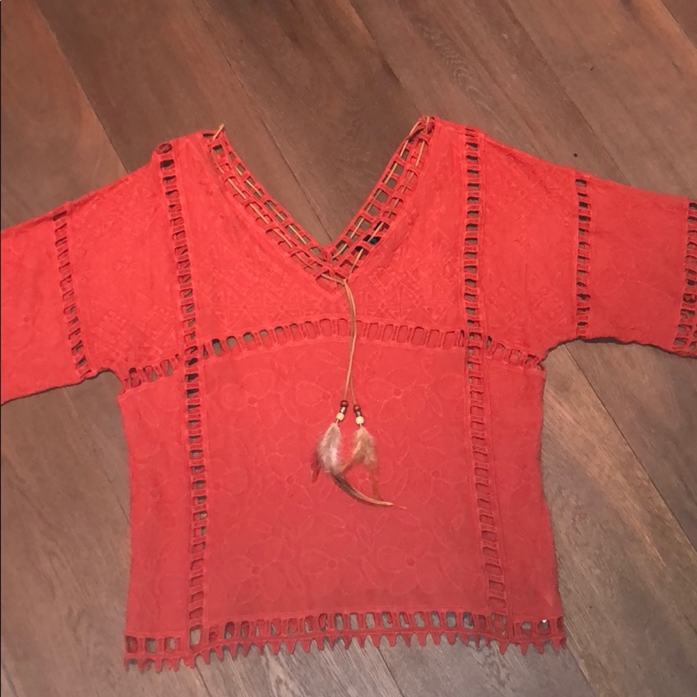 orange top with feathers